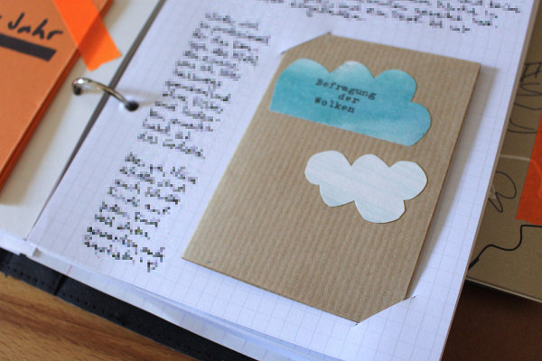 ein Zine das mit Hilfe von schrägen Einschnitten in ein Blatt Papier geklemmt ist